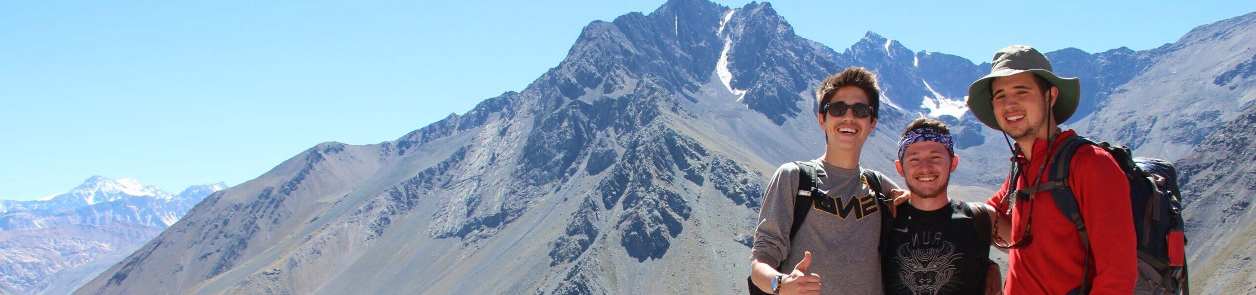 Students standing near a mountain